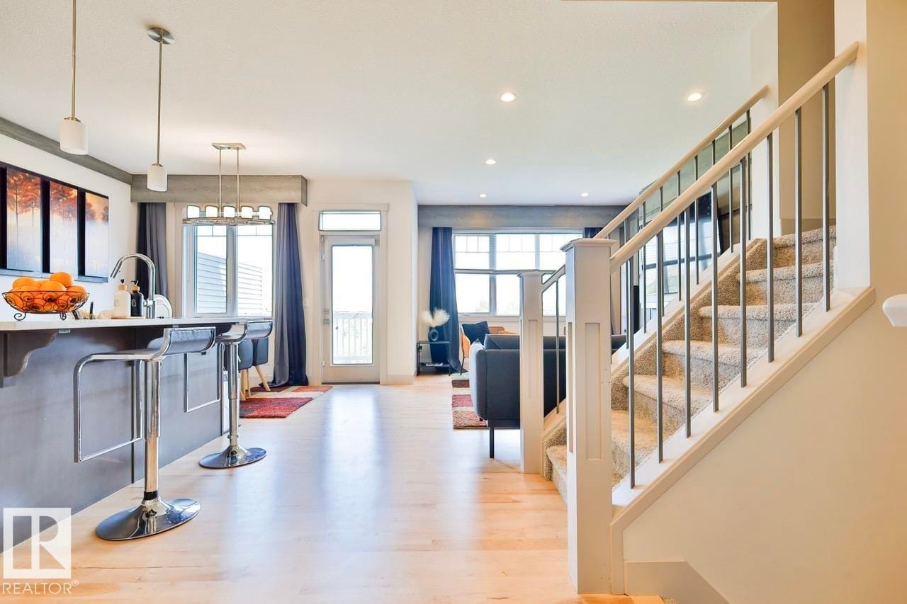 Kitchen bar seating looking toward the entry and staircase