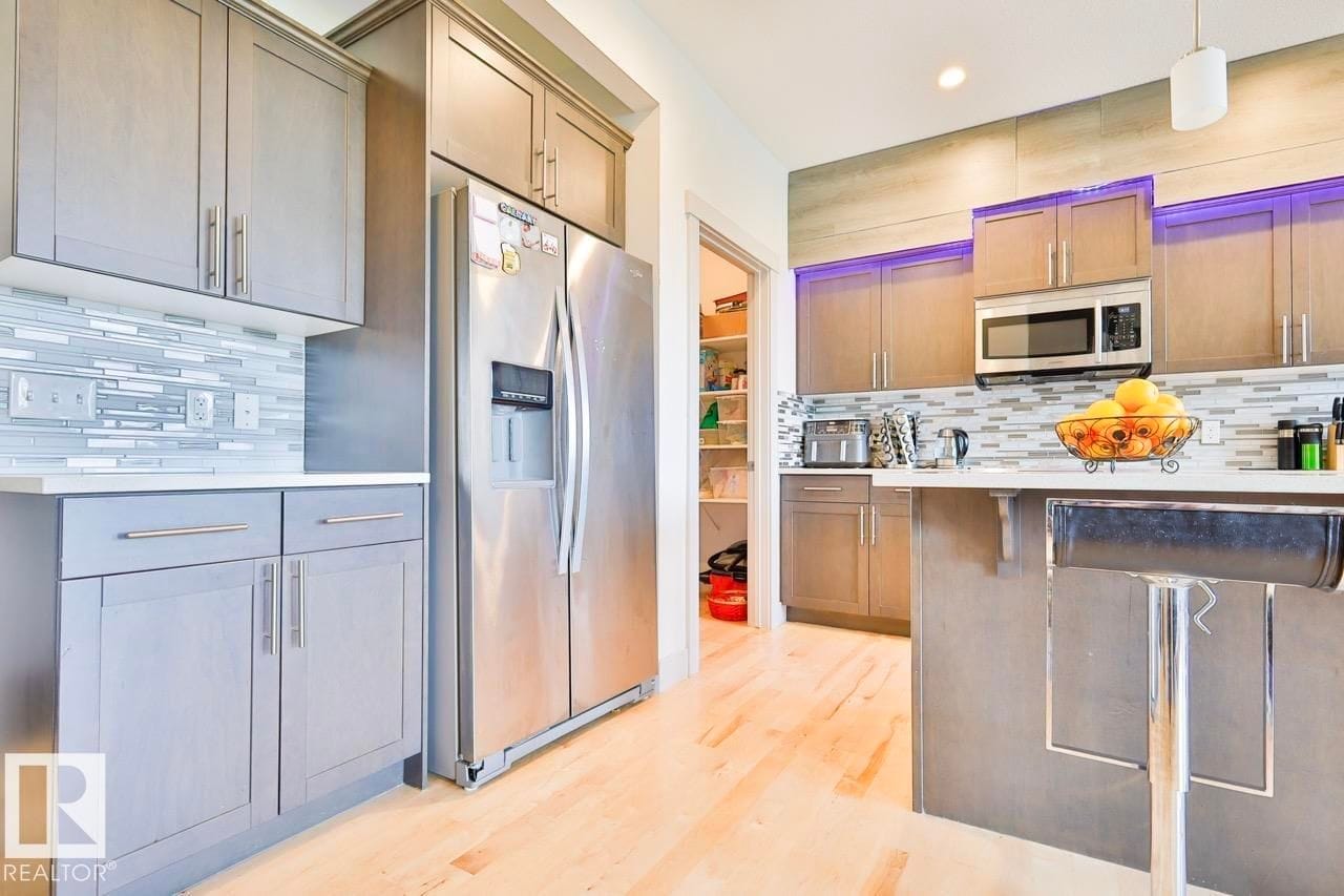 Kitchen with stainless refrigerator and cabinetry