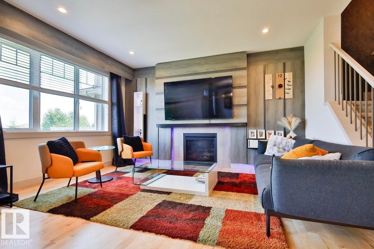 Living room with fireplace and mounted television