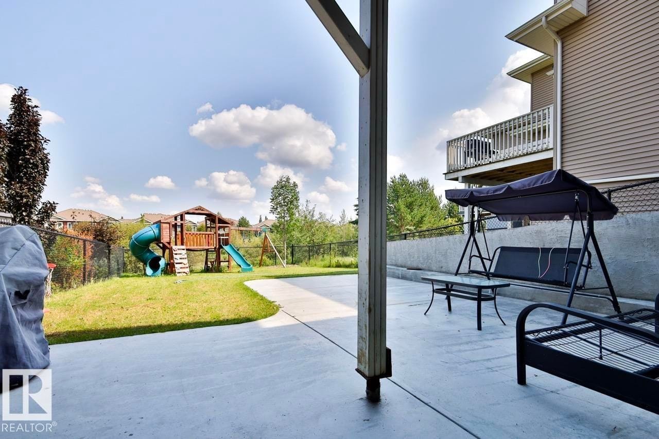 Rear yard with patio and play structure beyond