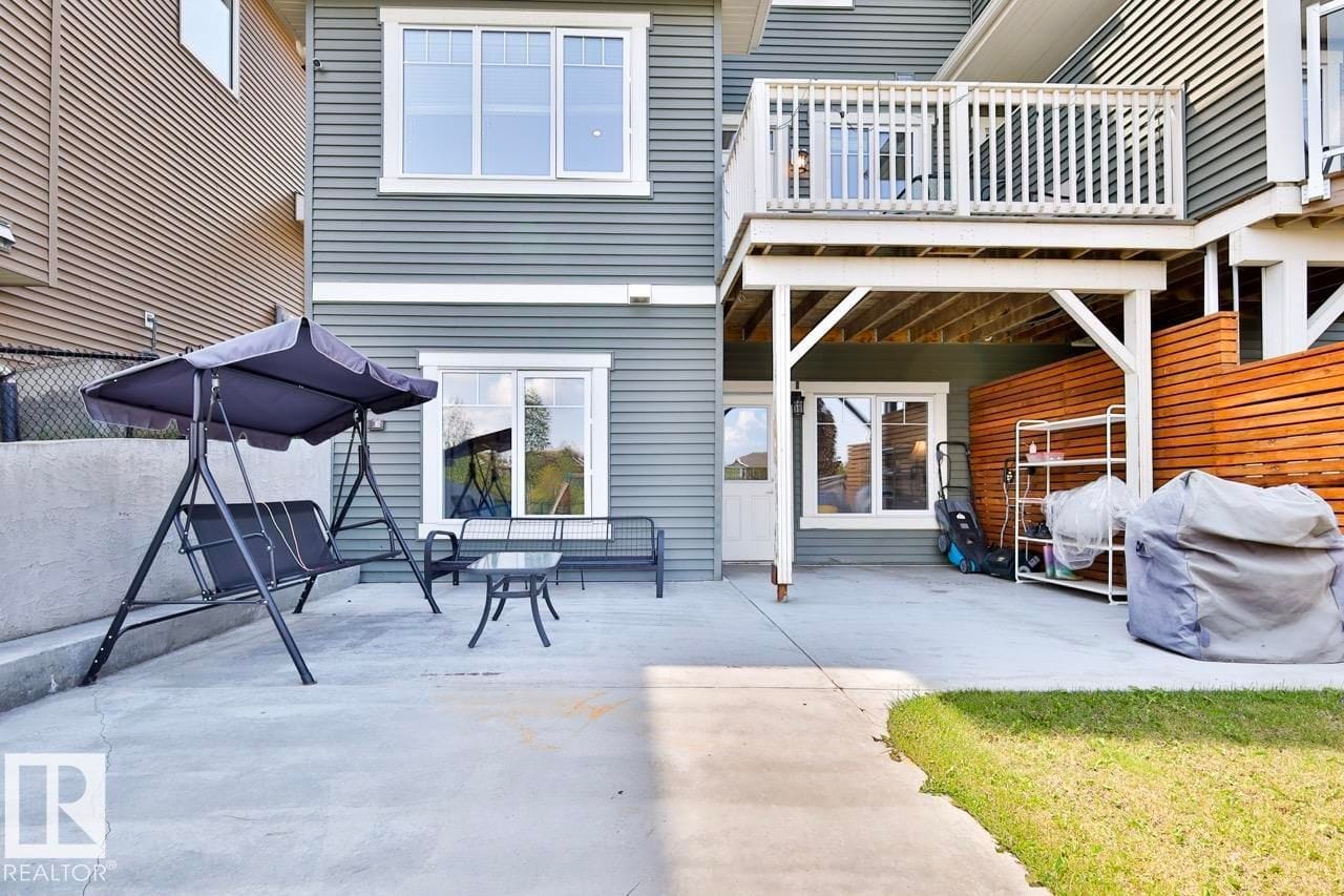 Rear exterior with upper deck above the walkout patio