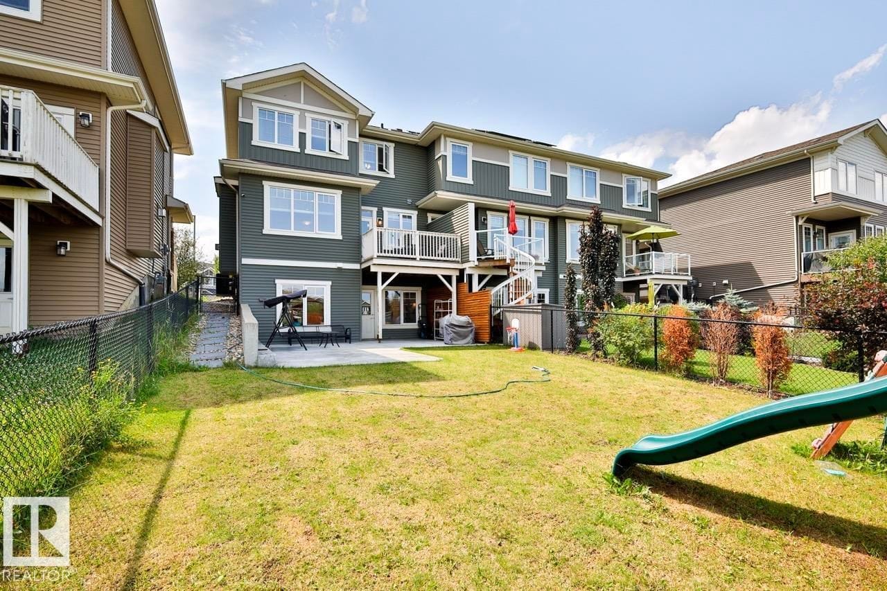 Rear elevation with the deck above the walkout level and fenced yard