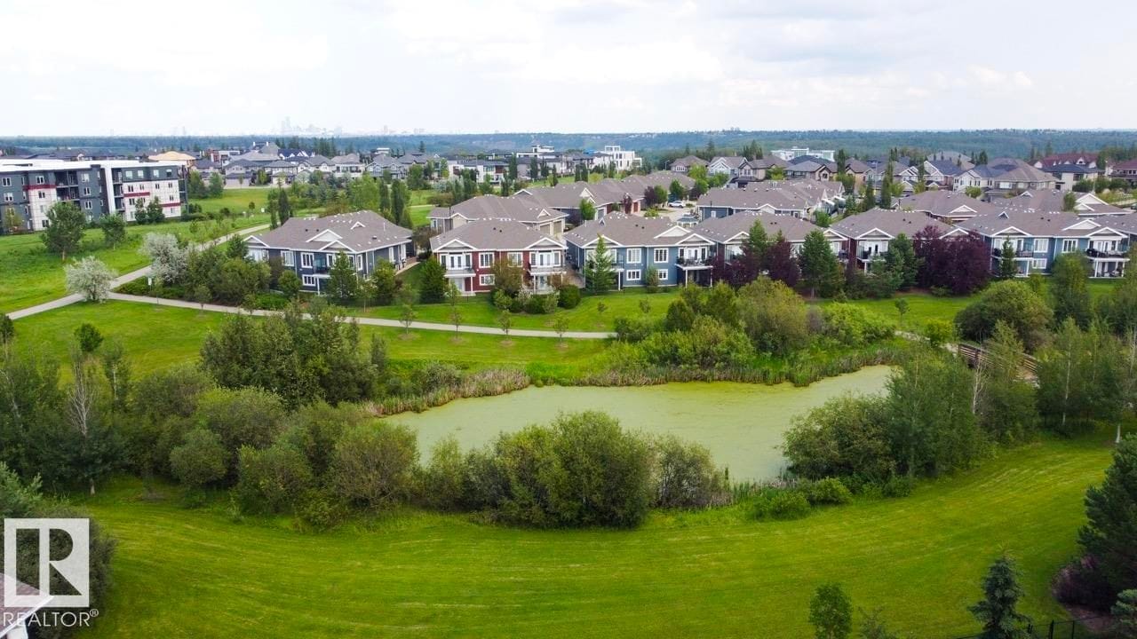 Aerial view of the pond and surrounding homes