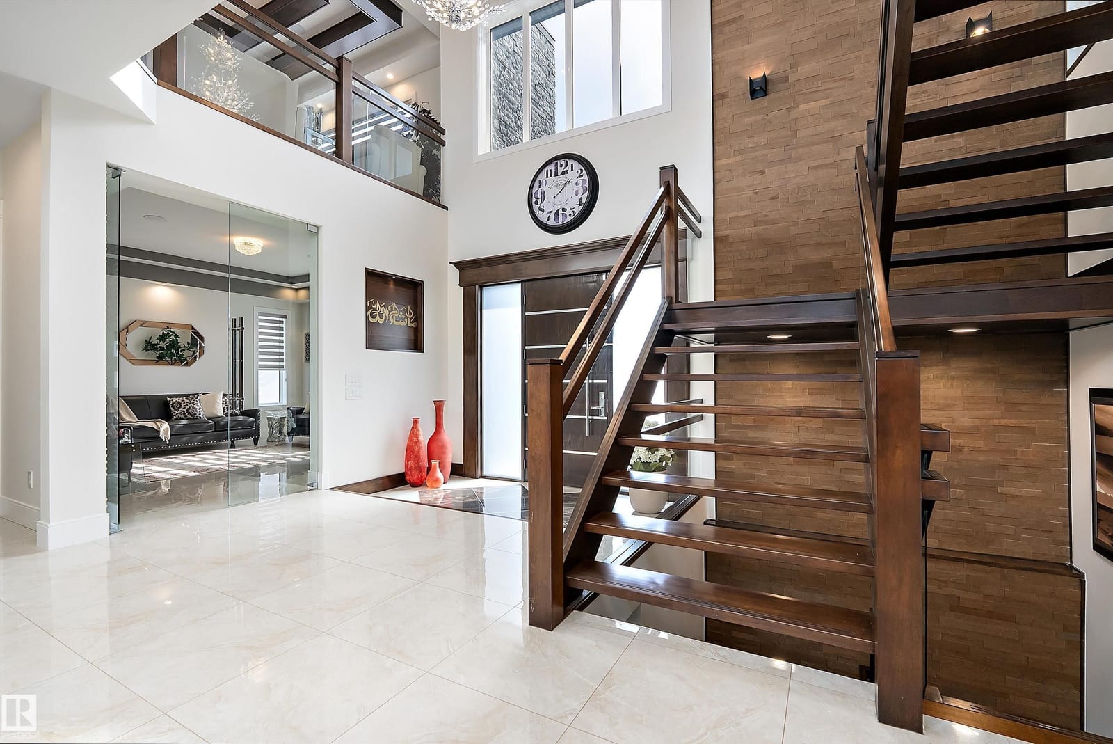 Open riser staircase in wood and glass off the foyer
