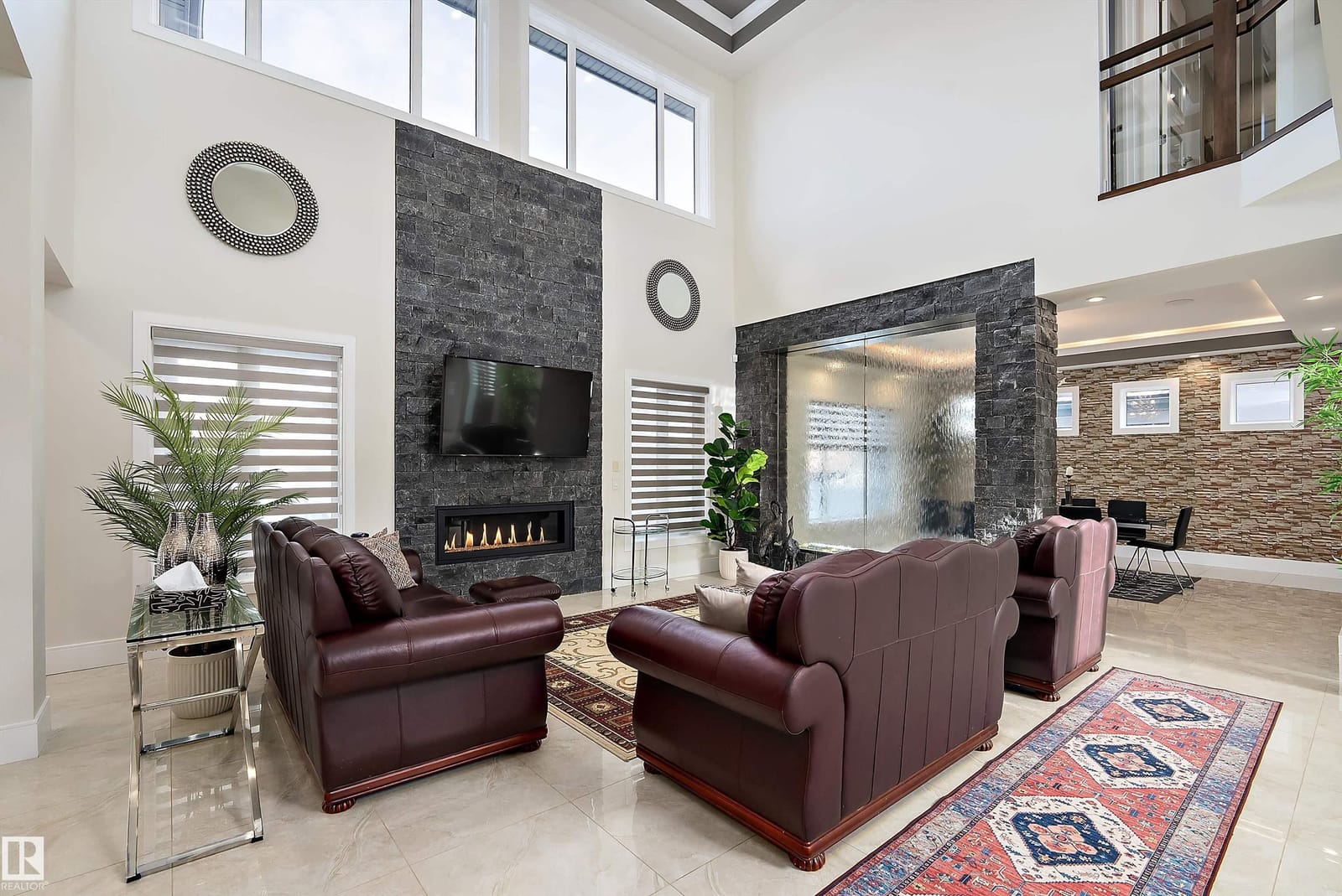 Living room with floor to ceiling stone fireplace