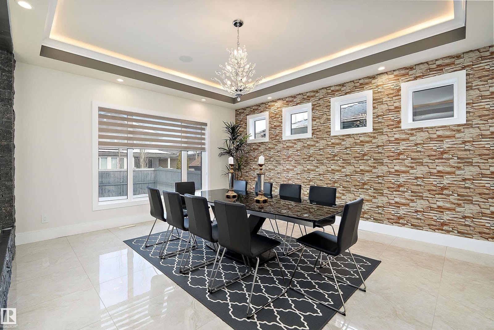 Formal dining room with chandelier and stone feature wall
