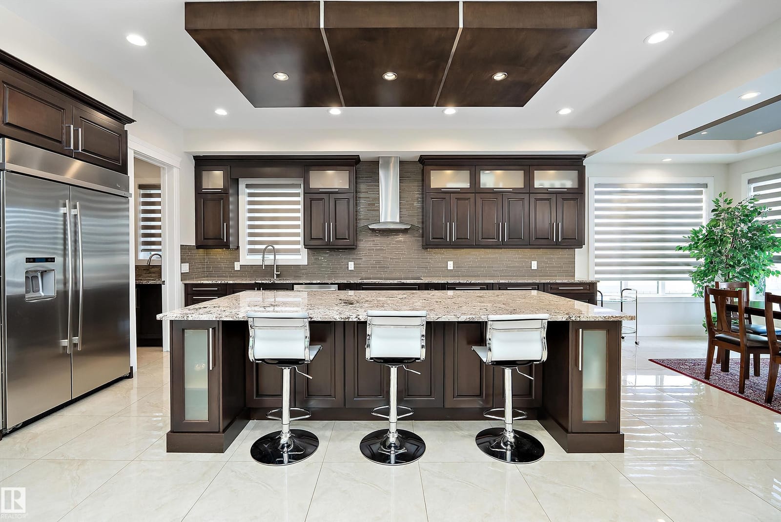 Kitchen with island seating and hood fan