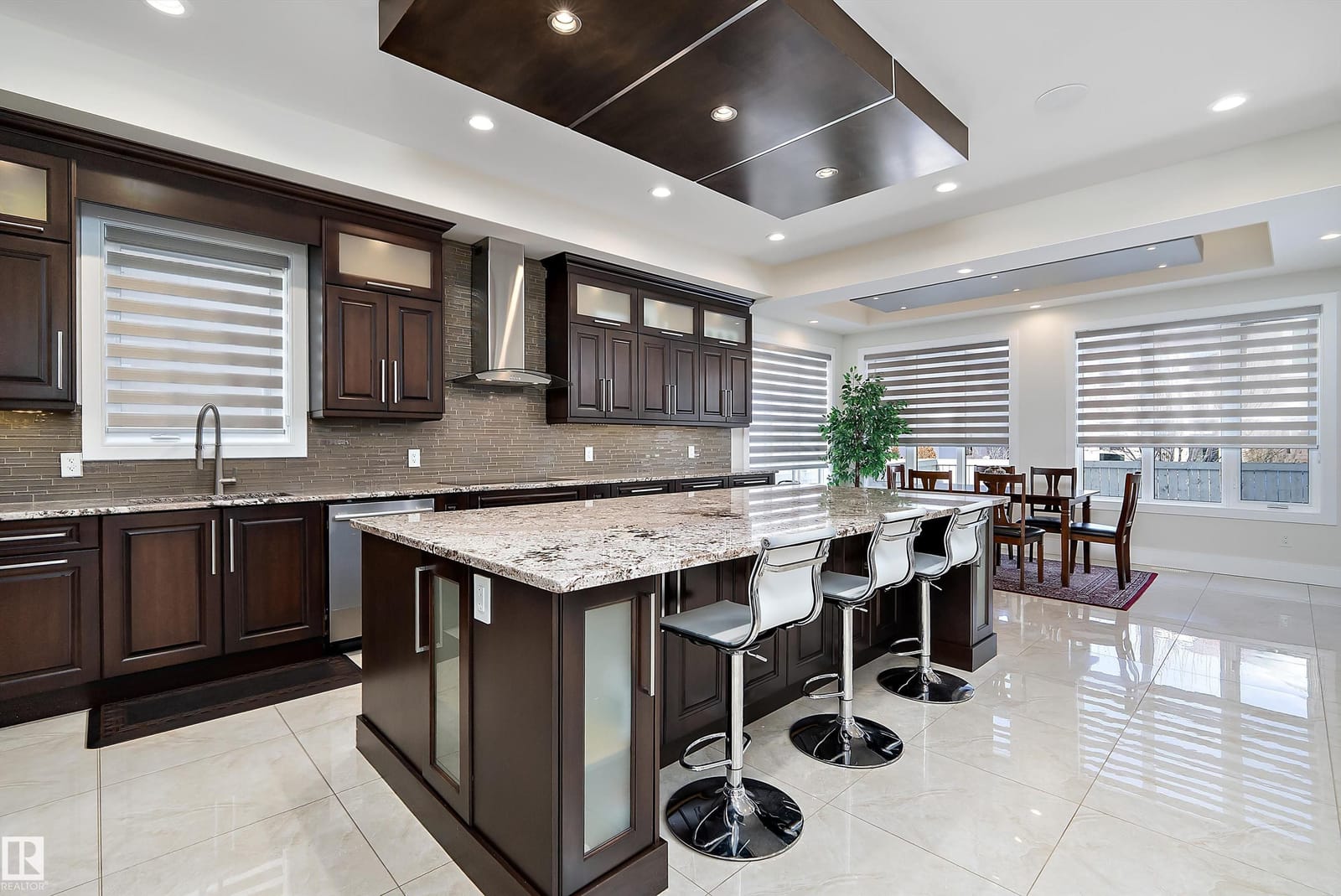 Kitchen island with breakfast seating beyond