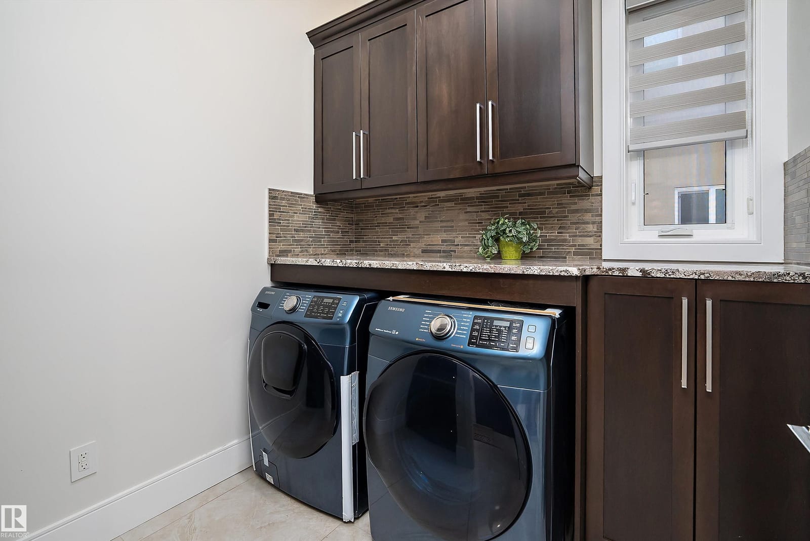 Laundry room with side by side washer and dryer