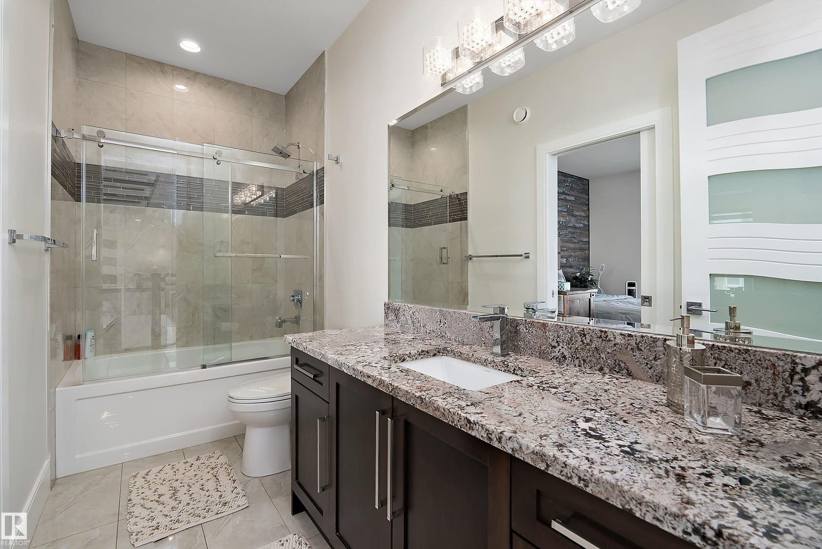 Ensuite with granite vanity and glass shower