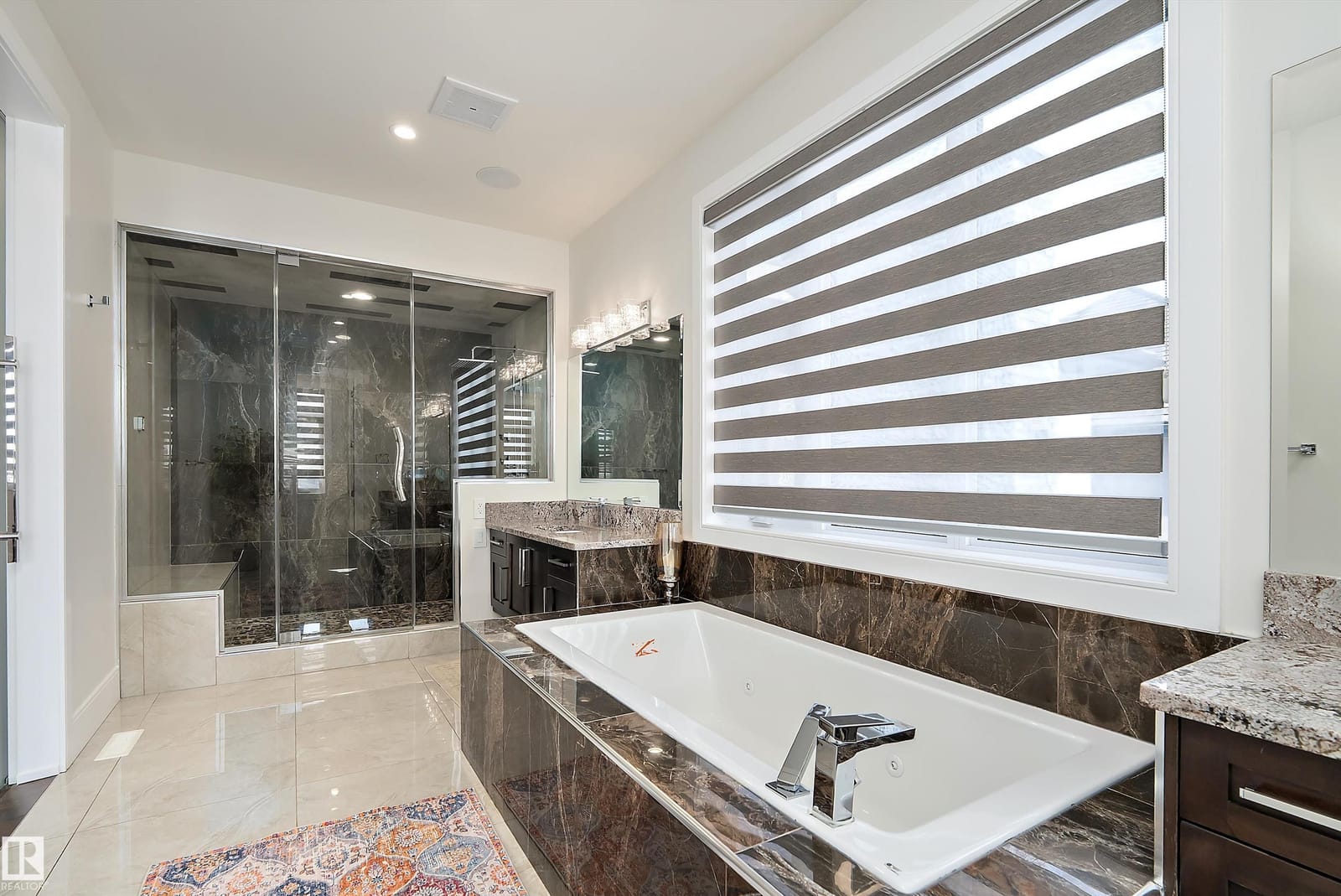 Ensuite soaker tub beside the glass shower