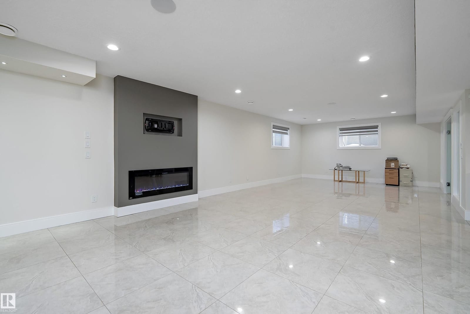 Lower level recreation room with linear fireplace