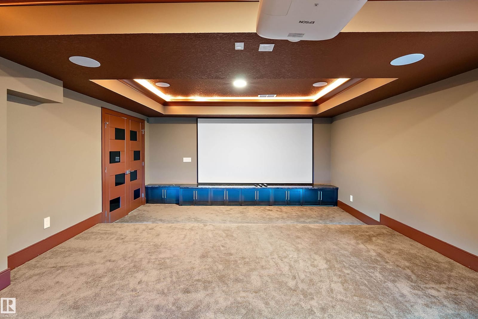 Home theatre with projection screen and tiered seating