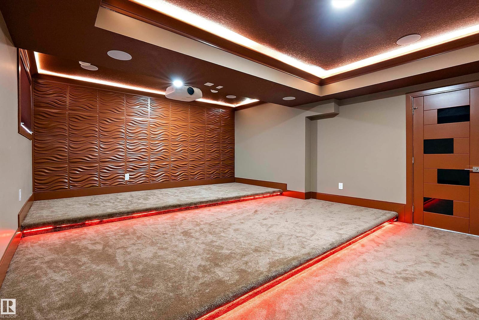 Home theatre with cove lighting and feature wall